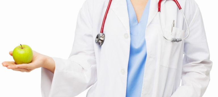 Midsection Of Doctor Holding Green Apple