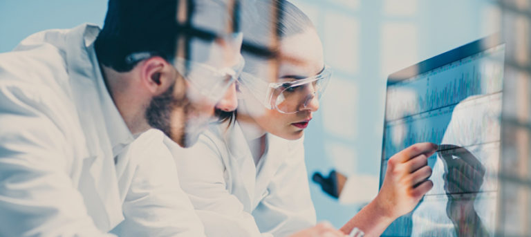 Doctors looking at computer screen with health information