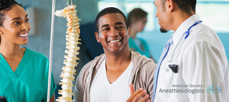 Doctors and patient talking and smiling