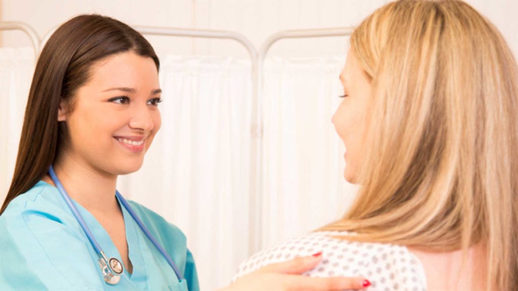 Two woman smiling at each other