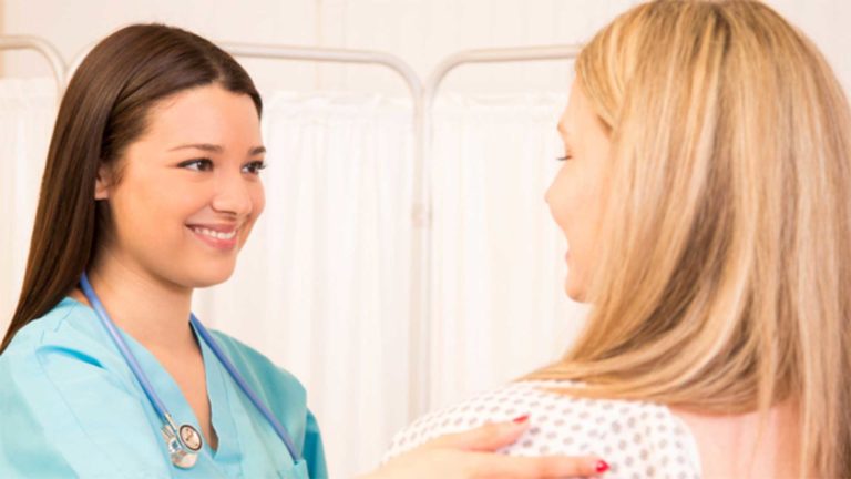 Two woman smiling at each other