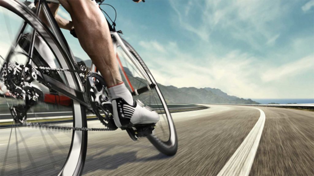 Person cycling on a bike on an open road
