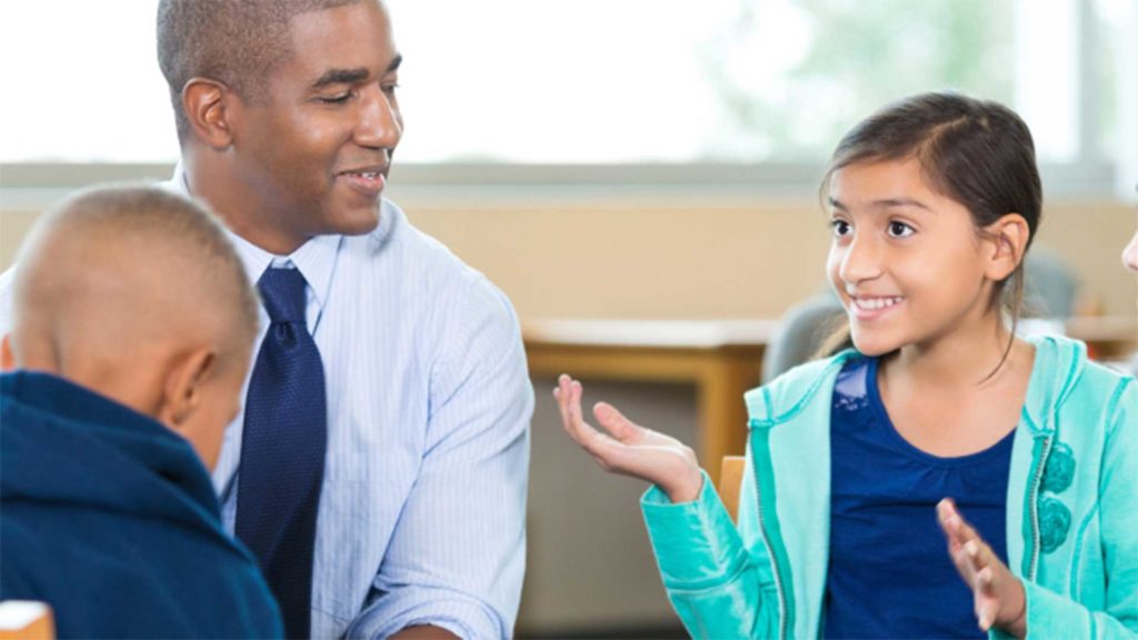 Child talking to a group of adults