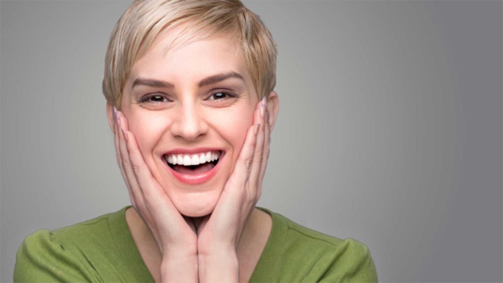 Young woman in green shirt, smiling
