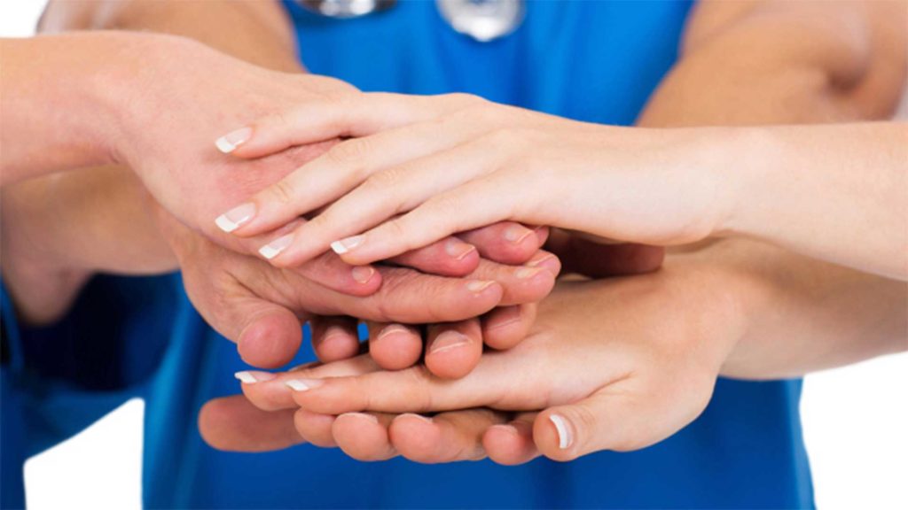 Multiple hands on top of each other