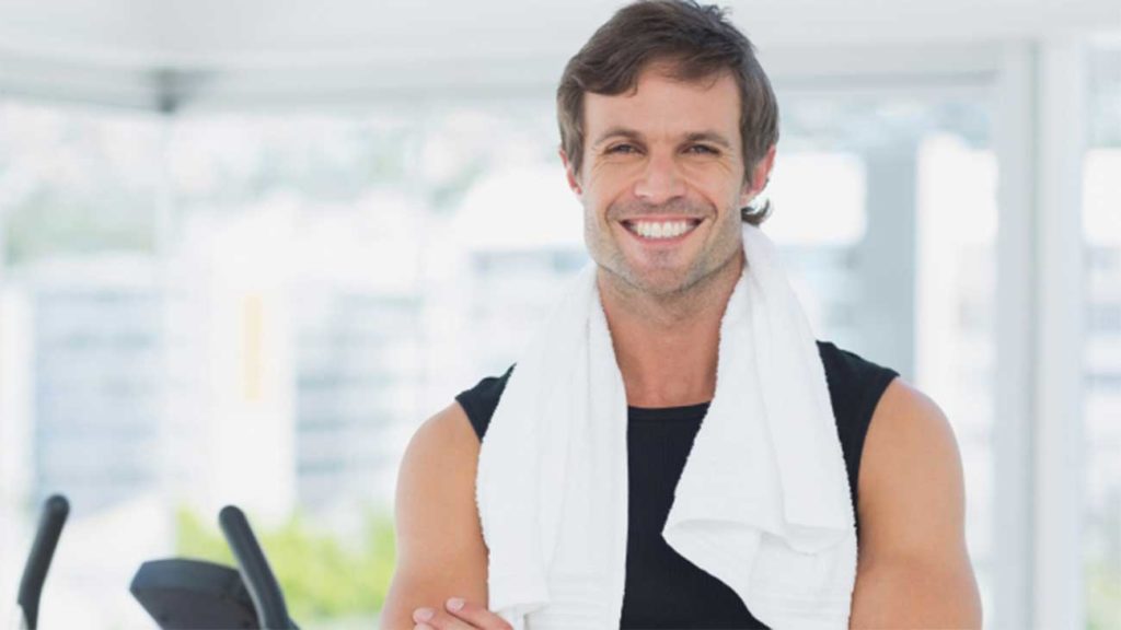 Man with white towel wrapped around neck and smiling