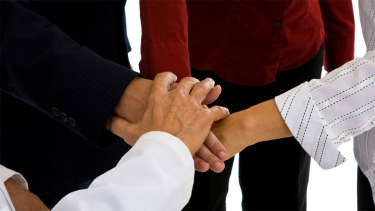 Multiple hands on top of each other