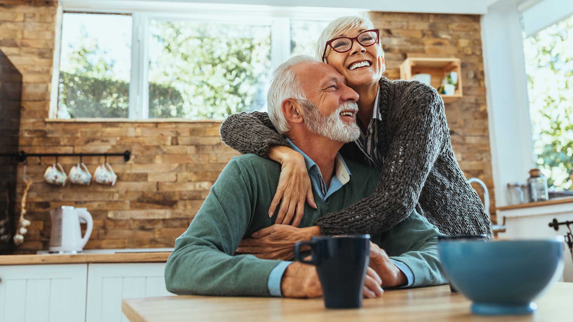 Elderly man and woman hugging