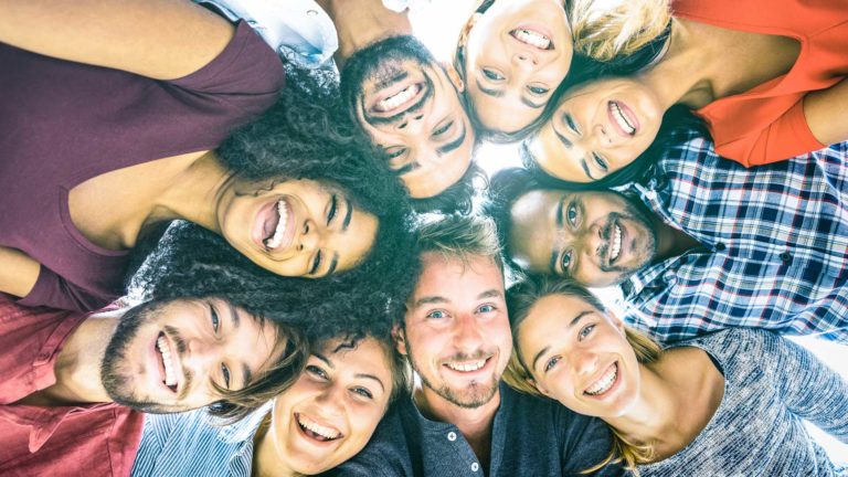 Group of people looking down and smiling