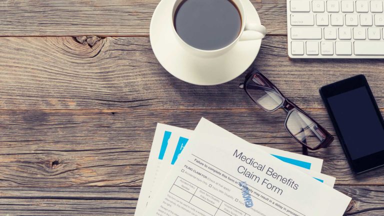 Medical benefits form on a wooden desk